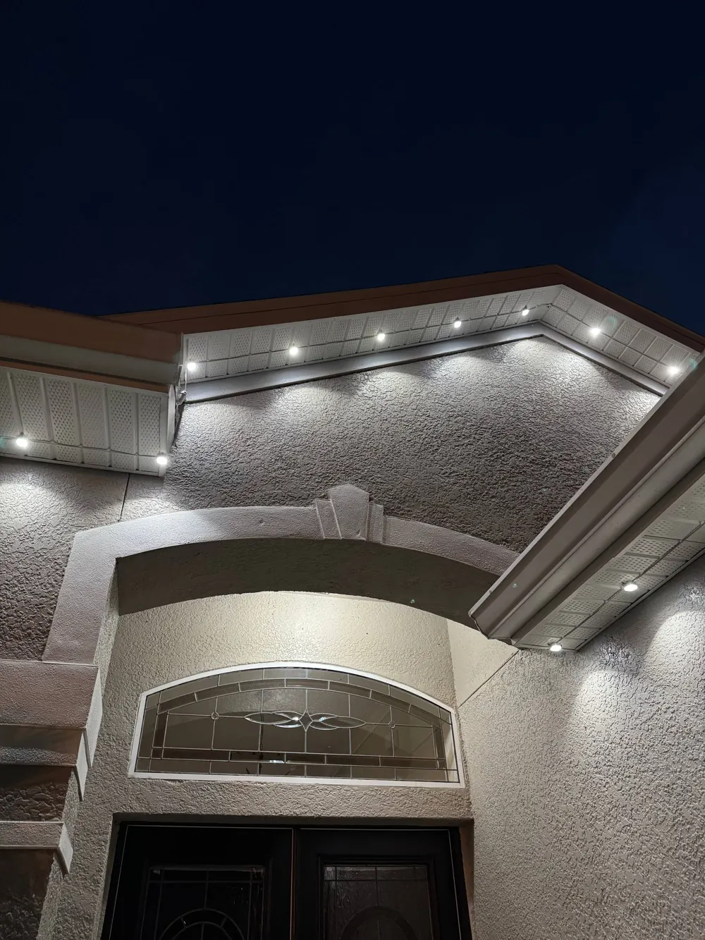 Evenly spaced lights following the entry arch